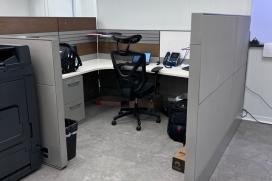 A black chair pulled into a cubicle in CertainTeed's Winter Haven, FL location 