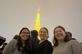 Three EOM engineers pose in front of the Eiffel Tower in Paris