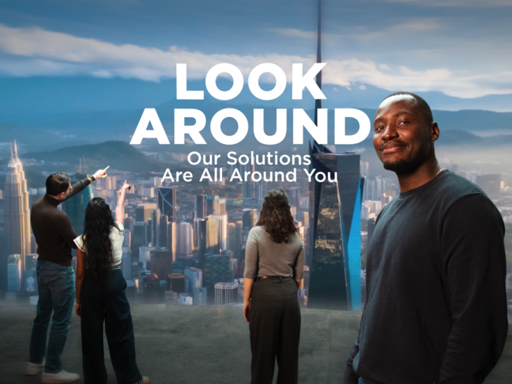 People overlooking a city skyline. Text reads: "Look around. Our solutions are all around you."