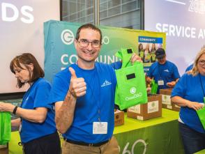 Man giving a thumbs up holding a Good360 hygiene kit