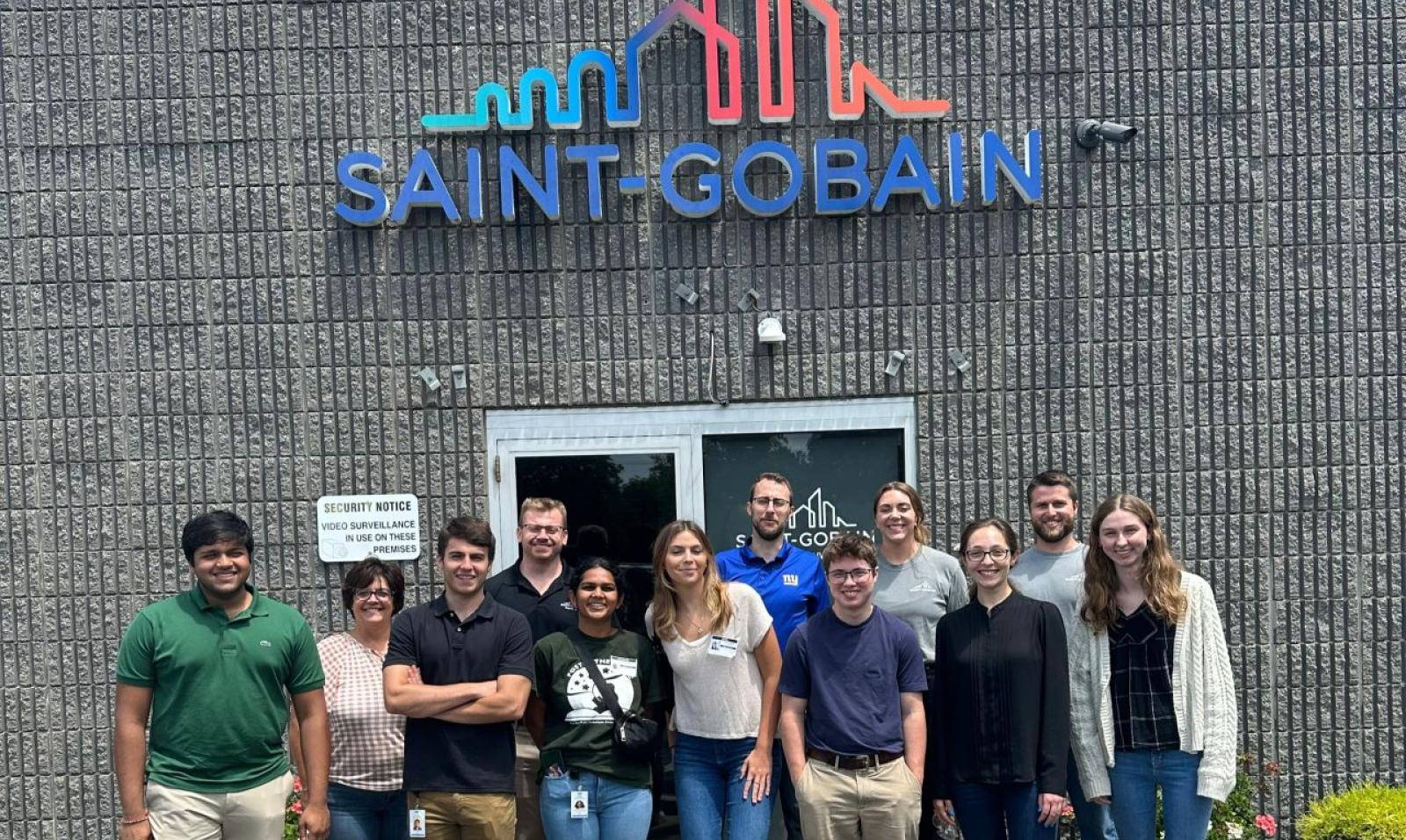 A close-up of happy employees at Saint-Gobain talking about careers with training programs.