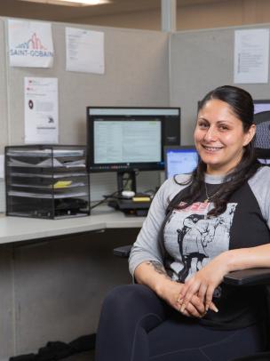Administrative employee working in a modern office environment with computer workstations.